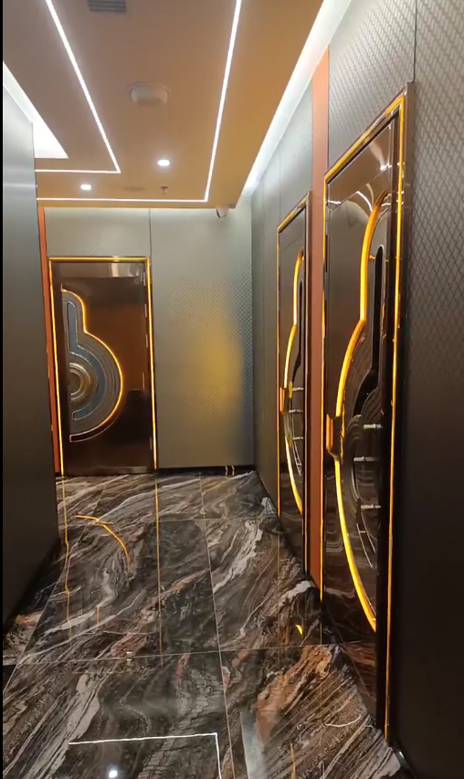 Luxury KTV hallway featuring soundproof doors with LED lighting, designed for high-end entertainment spaces