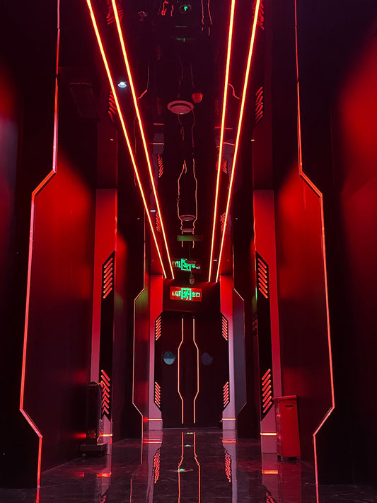 Luxury KTV venue showcasing stylish soundproof door installation with vibrant red LED lighting, ideal for premium entertainment spaces