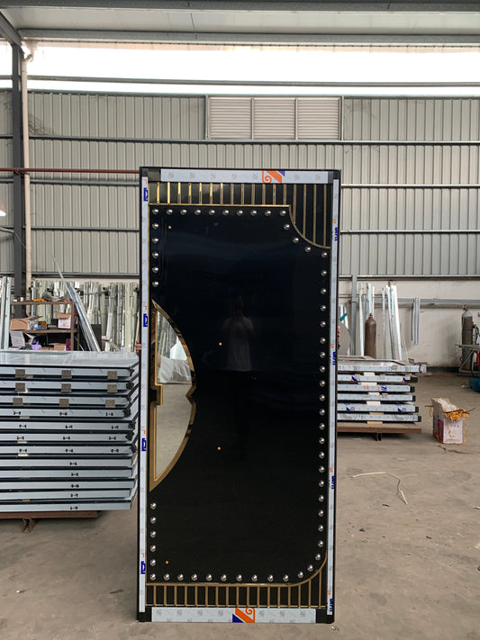 High-performance multi-layered soundproof fire door with black gloss surface, gold trims, and studded design — engineered for heat, sound, and safety integration.