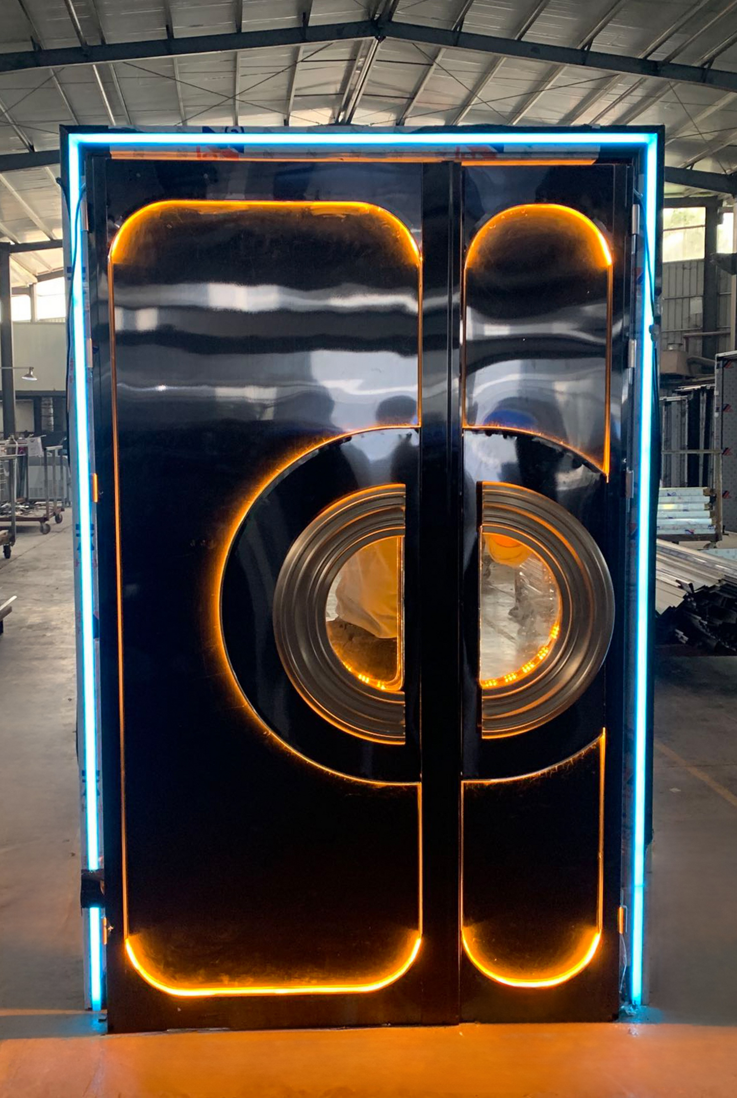Luxury double LED soundproof door with golden-orange lighting and mirrored stainless steel round design – great for high-end KTV or club entrance