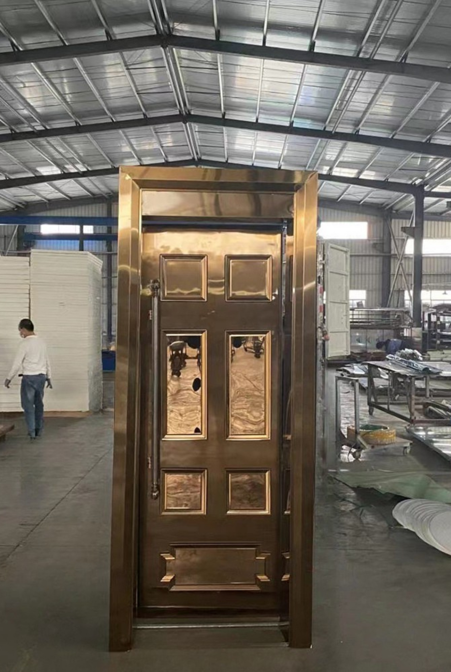 Elegant copper soundproof door with symmetrical inlaid rectangular panels, designed for luxurious sound-controlled environments.