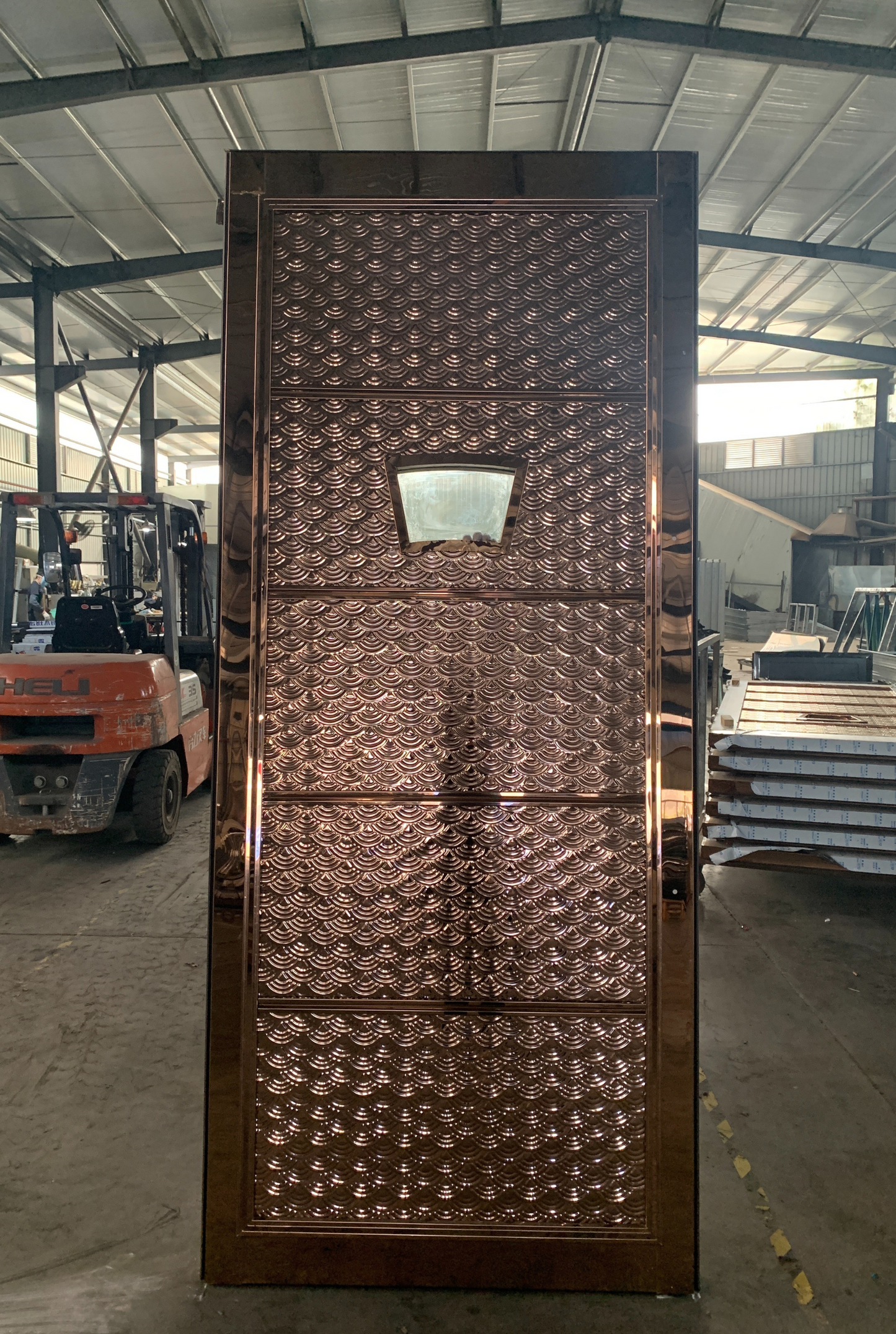 Bronze stainless steel soundproof door with intricate wave pattern design and a small observation window, ideal for upscale KTV rooms or clubs.
