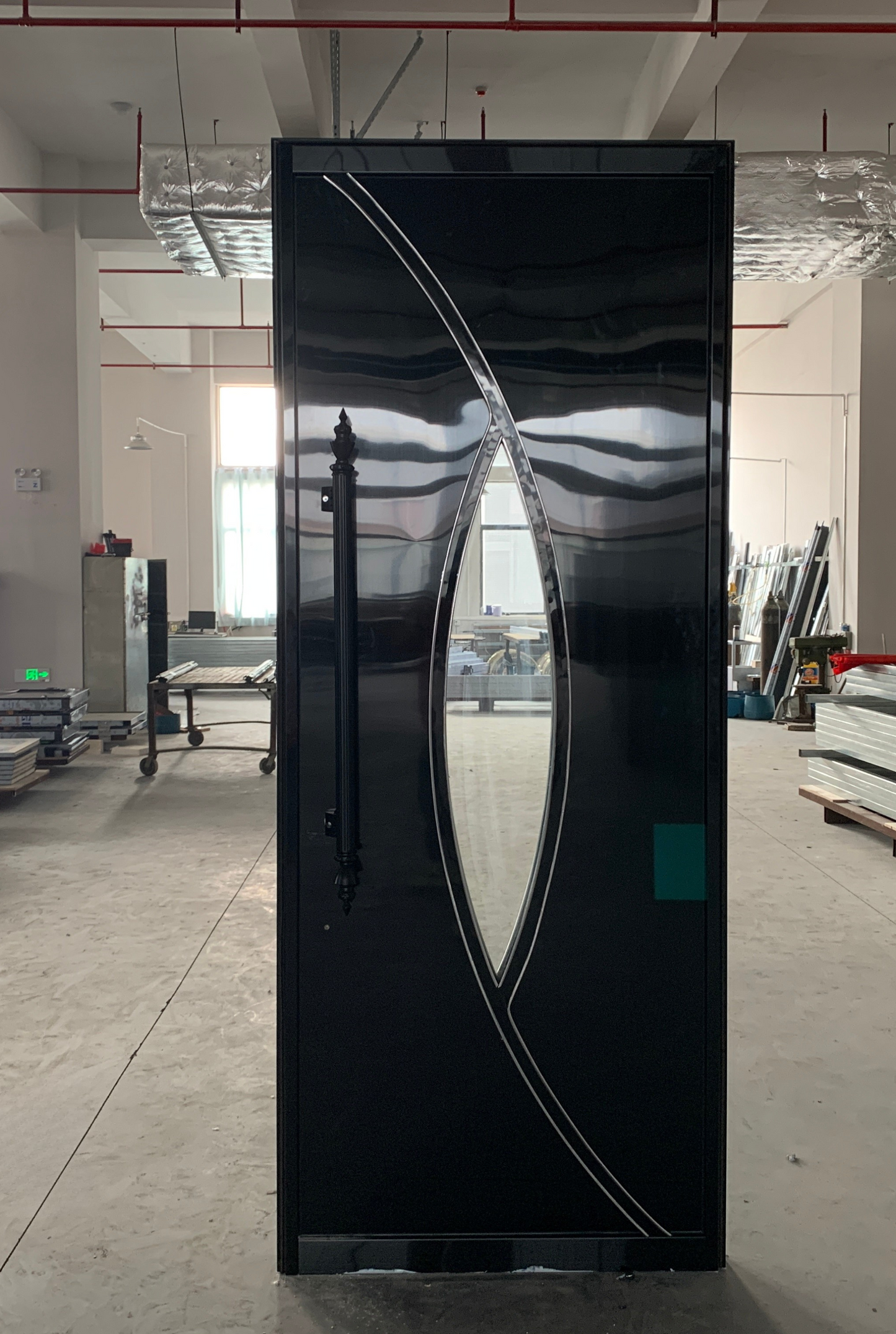 Glossy black soundproof door with wave-cut mirror accent – sleek and futuristic style