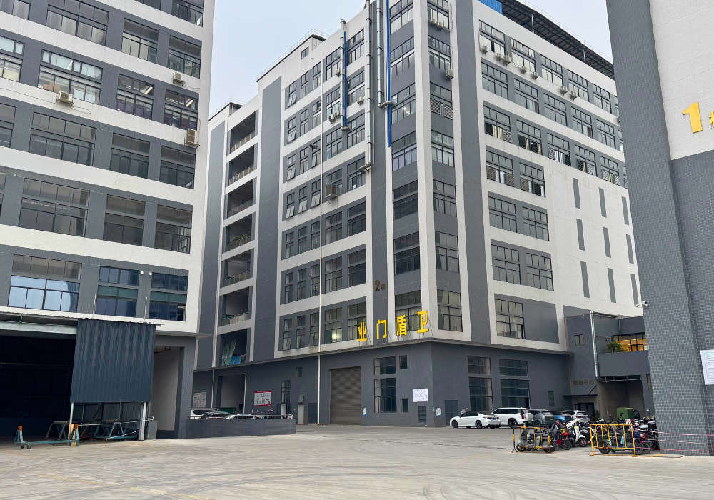 Exterior view of the factory building showcasing the production area and company signage, highlighting the manufacturing facility for soundproof doors.
