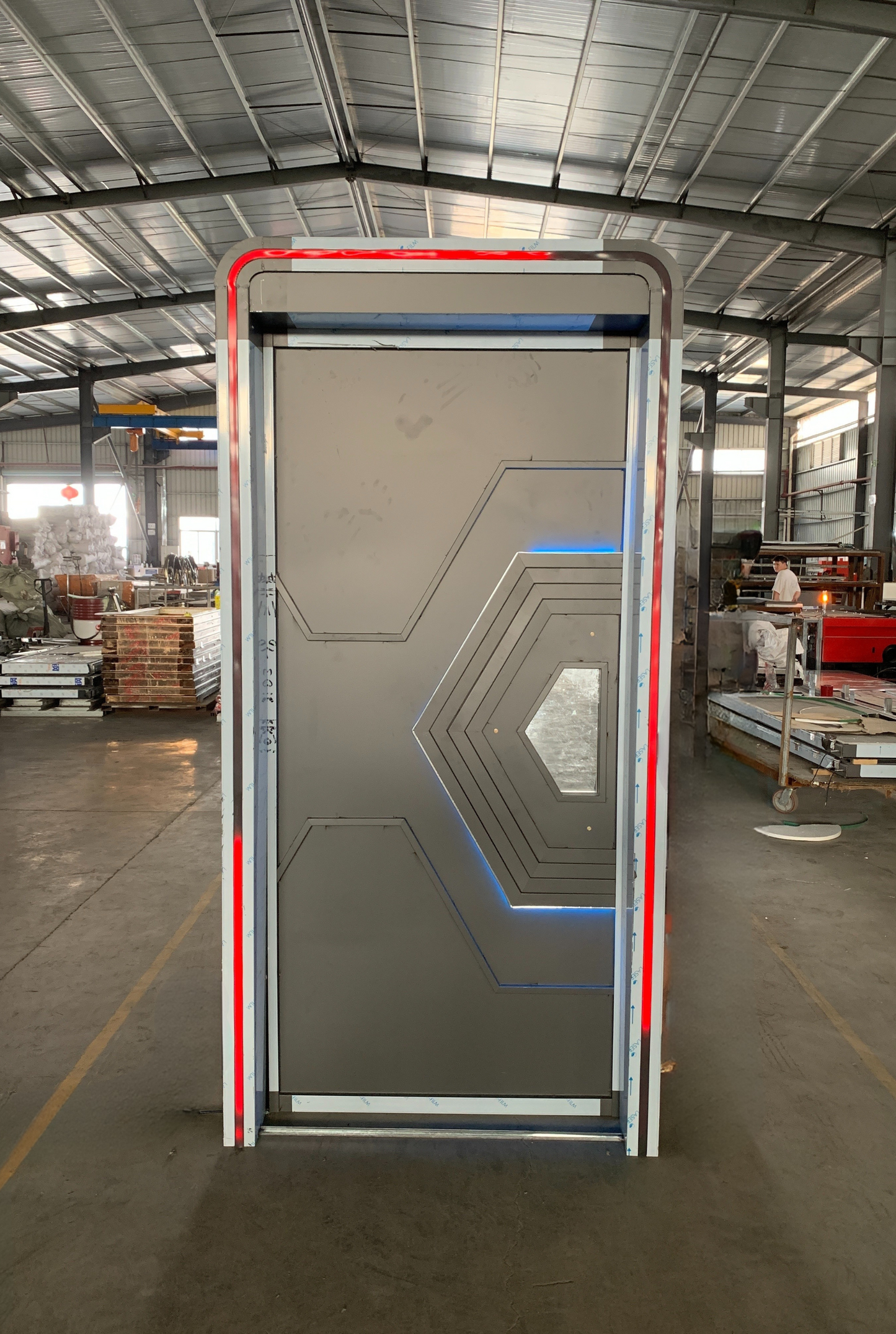 Futuristic soundproof door with hexagonal geometric design, metallic grey finish, and red-blue LED lighting – perfect for sci-fi clubs or gaming rooms