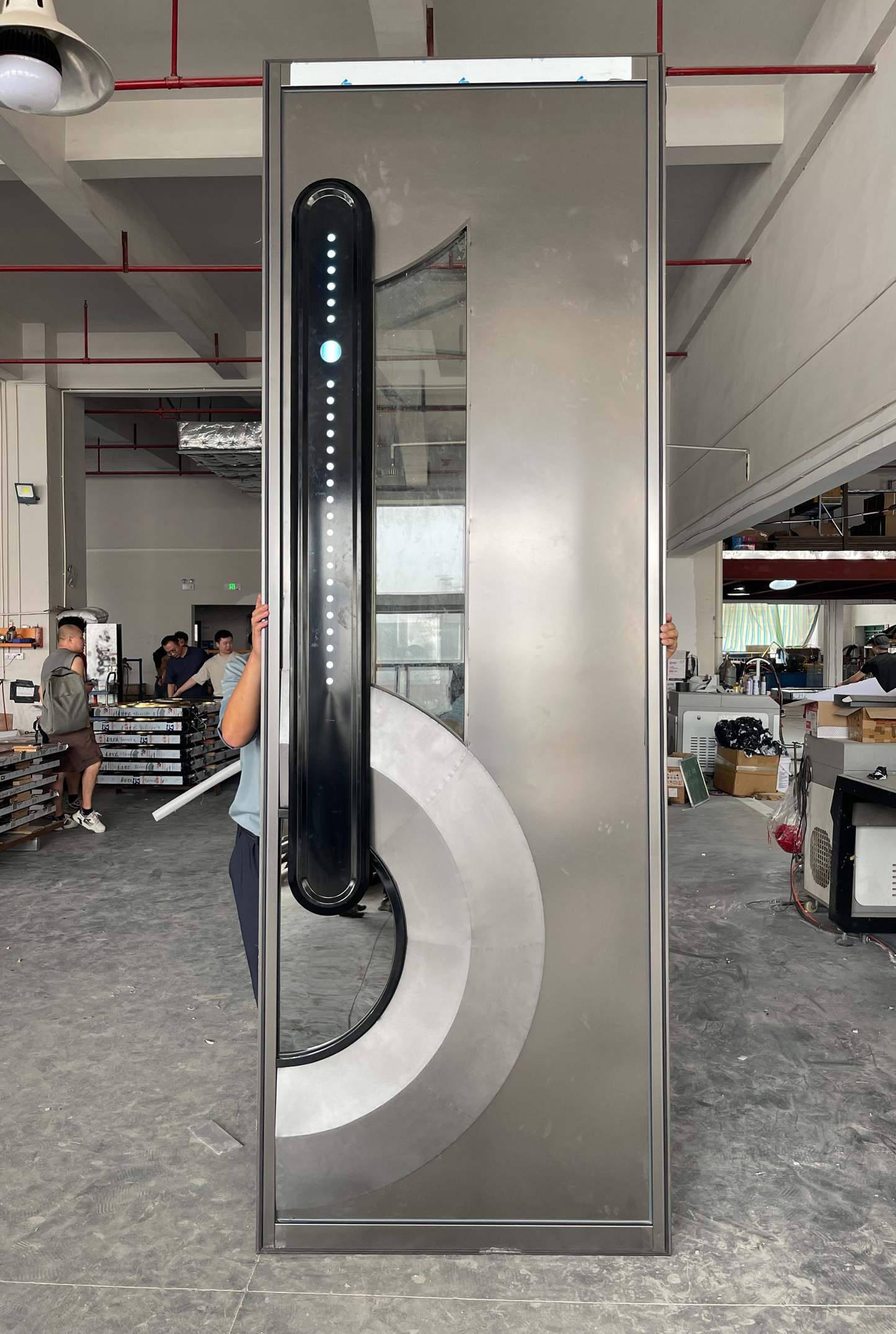 Stainless steel soundproof door with vertical LED strip and semi-circular glass window, designed in minimalist modern style for tech rooms or home theaters