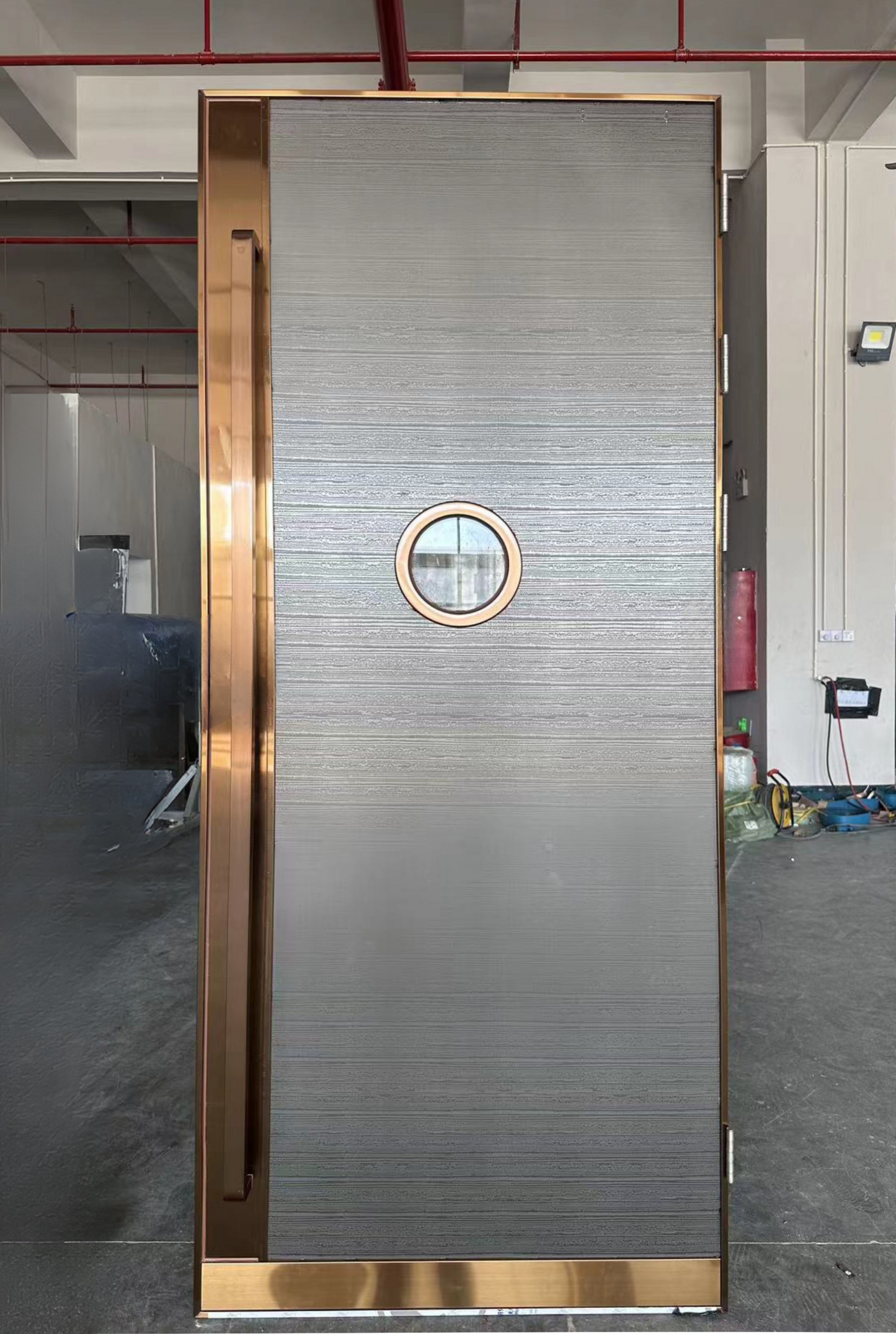 Flat soundproof door with horizontal texture, bronze frame, and round vision window