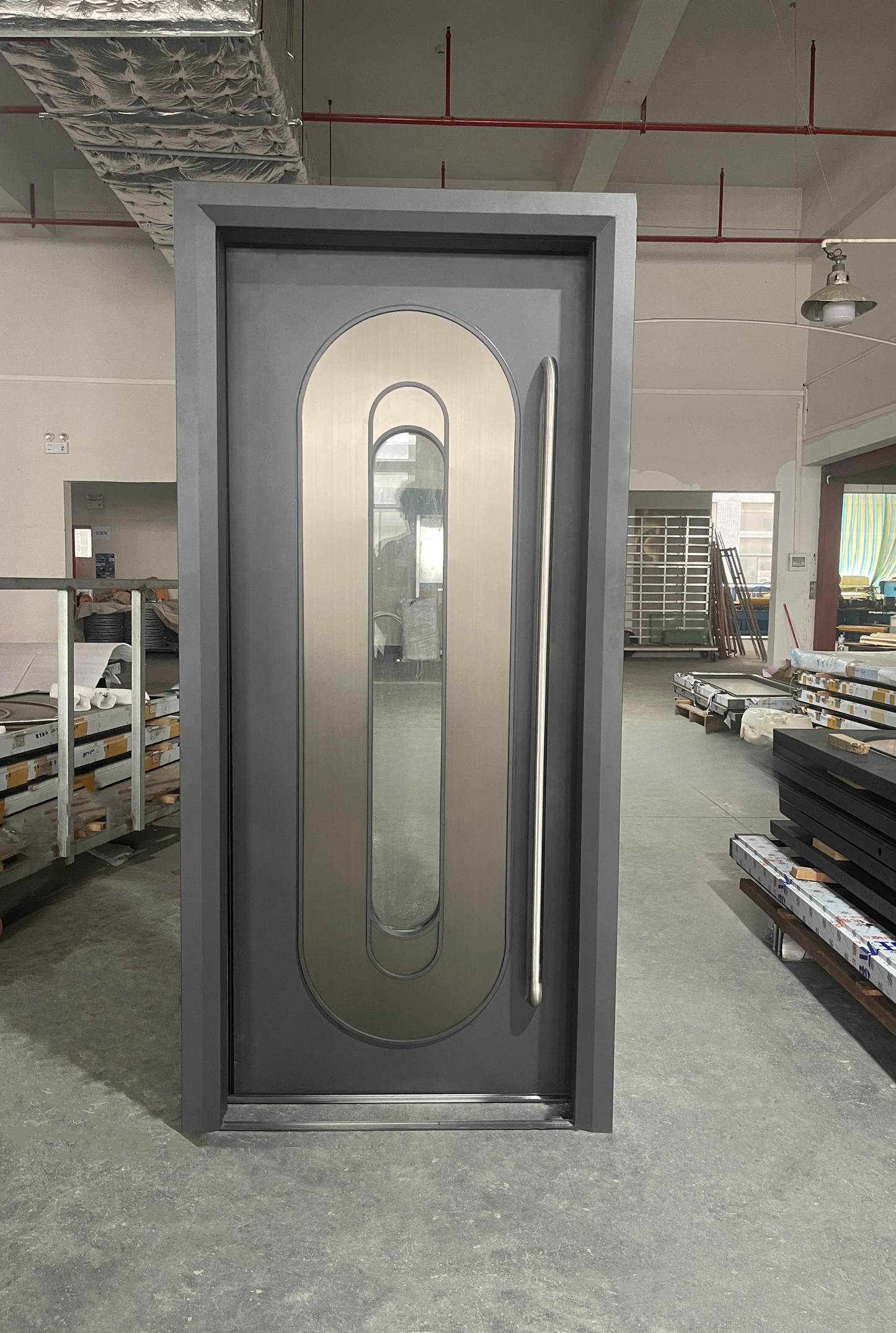 Flat black soundproof door with oval window cutout and brushed steel inlay – modern and stylish