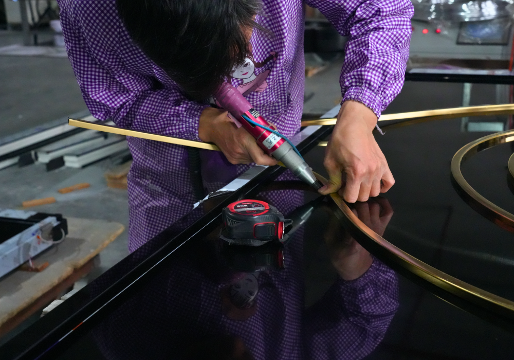 Worker assembling a soundproof door frame with a heat gun and measuring tape, ensuring precise fitting and quality craftsmanship in the production process
