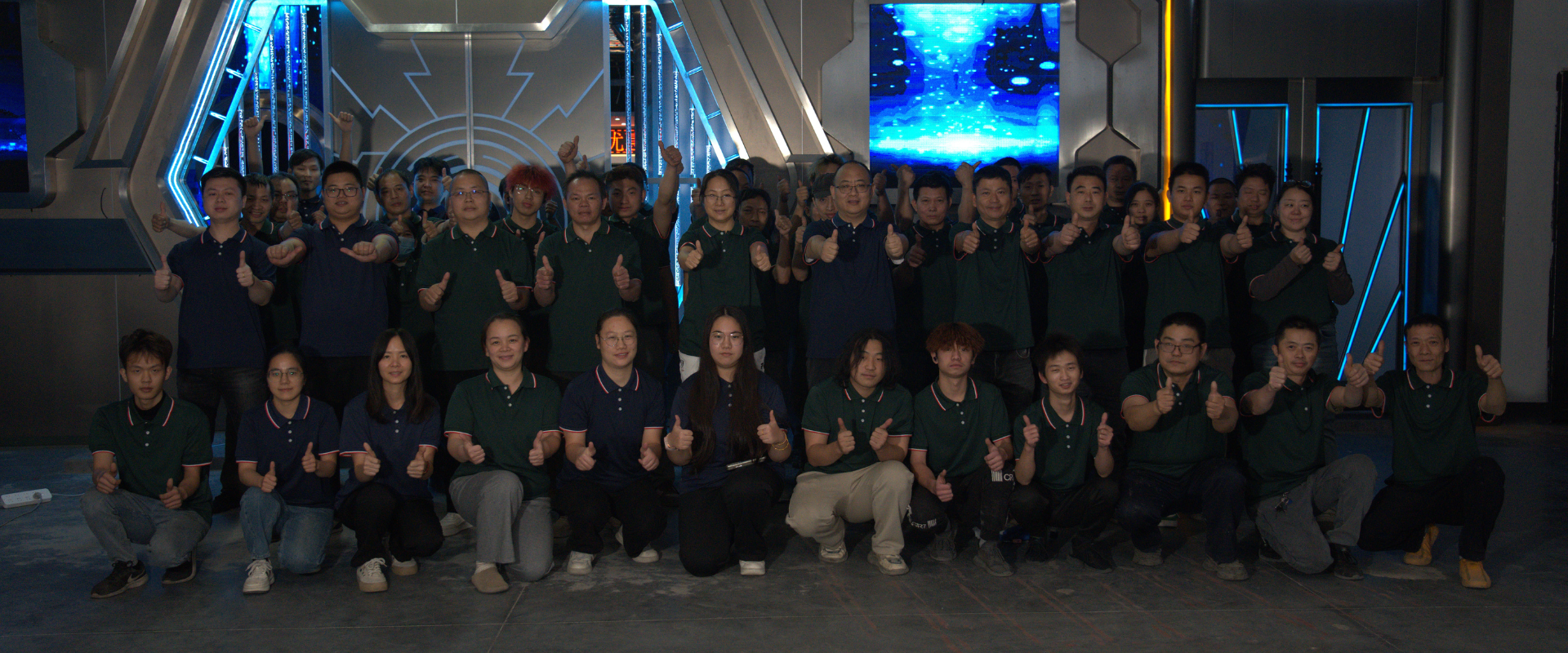 Team group photo with members giving thumbs up in front of the company’s high-tech KTV soundproof doors, reflecting the company's strong team spirit and commitment to quality